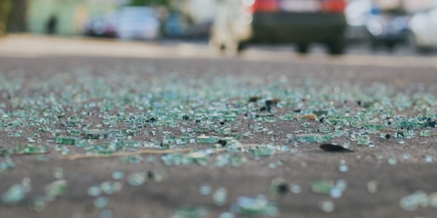 Broken glass scattered on road
